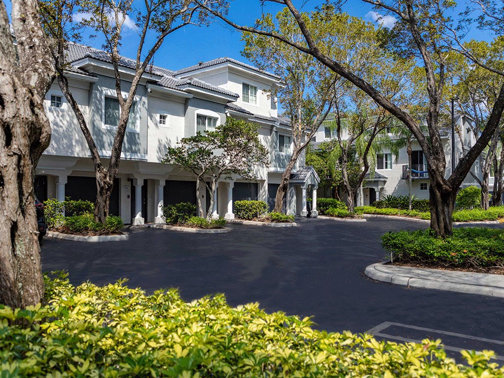 front view of the building with trees and bushes