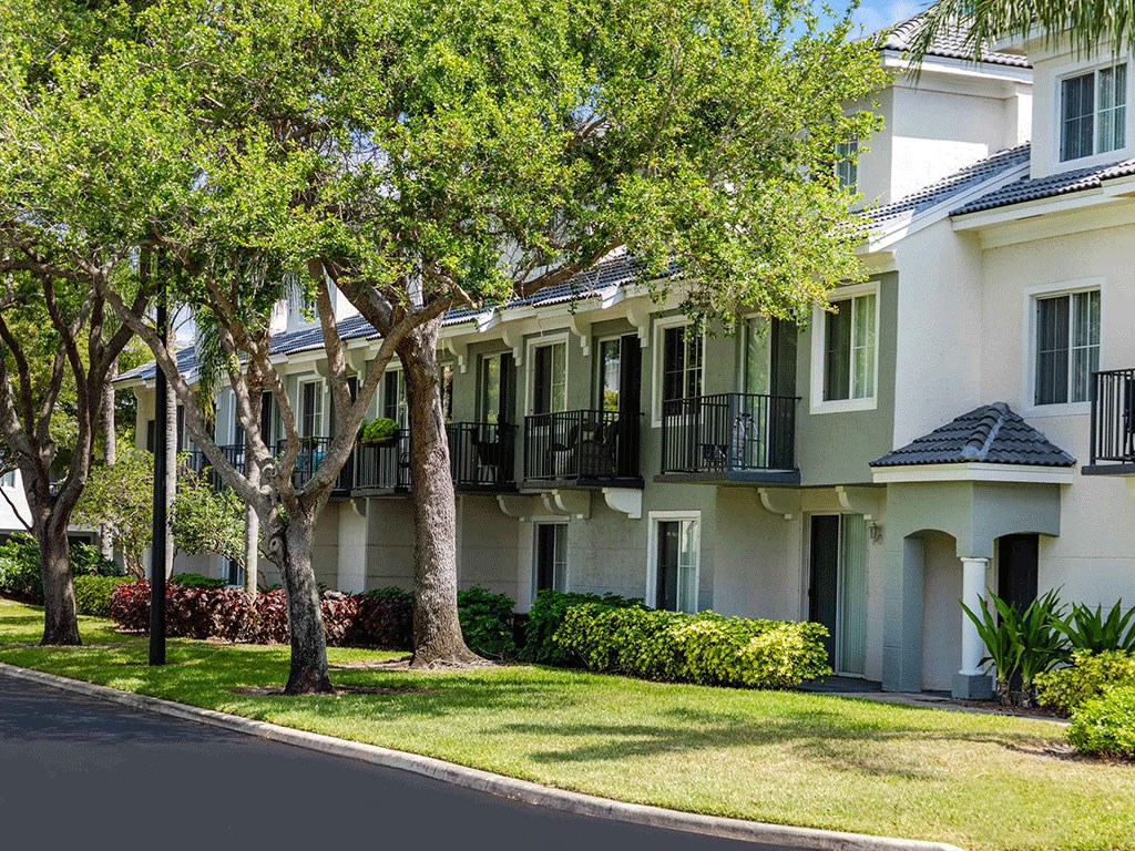 an apartment building with trees in front of it
