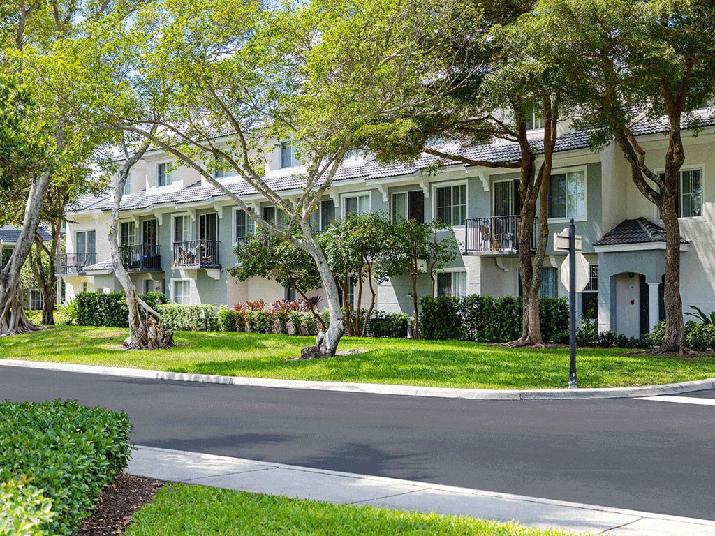 a large white building with trees in front of it