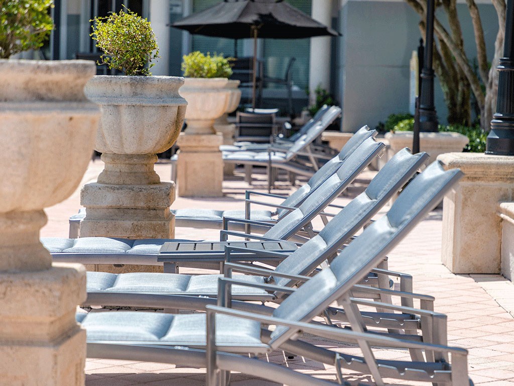 a row of lounge chairs on a patio