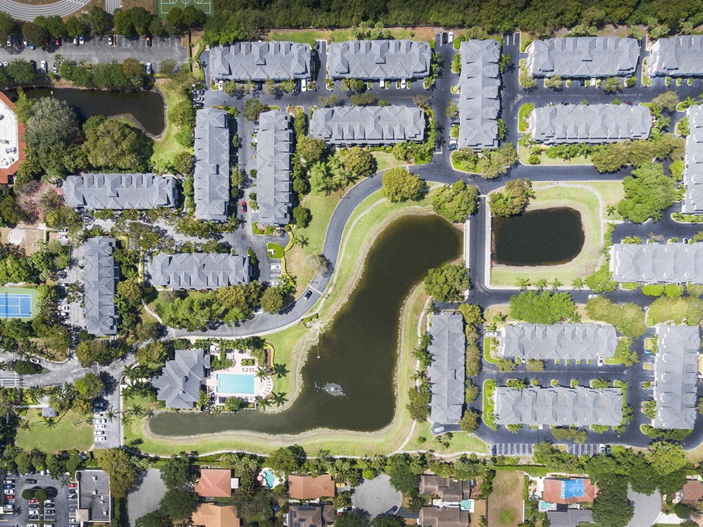 an aerial view of a neighborhood with a golf course in the middle