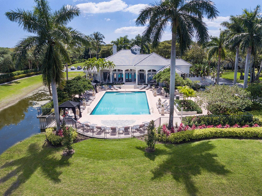 a mansion with a pool and palm trees