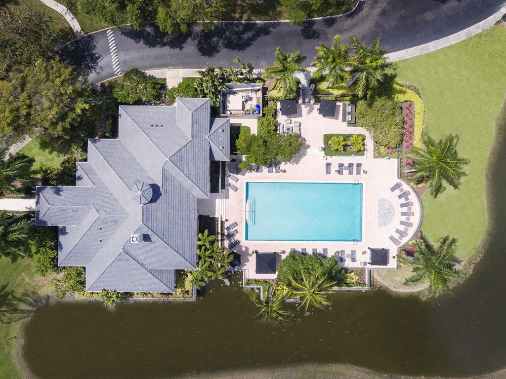 arial view of a mansion with a swimming pool on the property