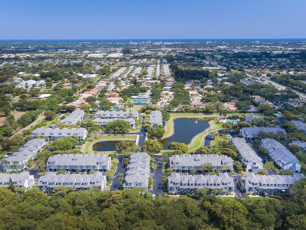 an aerial view of a neighborhood of houses and a lake
