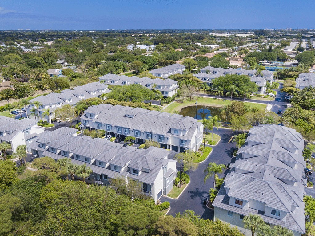 an aerial view of a group of houses surrounded by trees