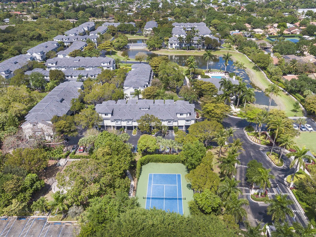 an aerial view of a neighborhood with houses and a swimming pool