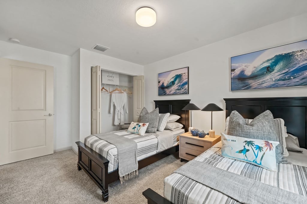 a bedroom with two beds and a closet