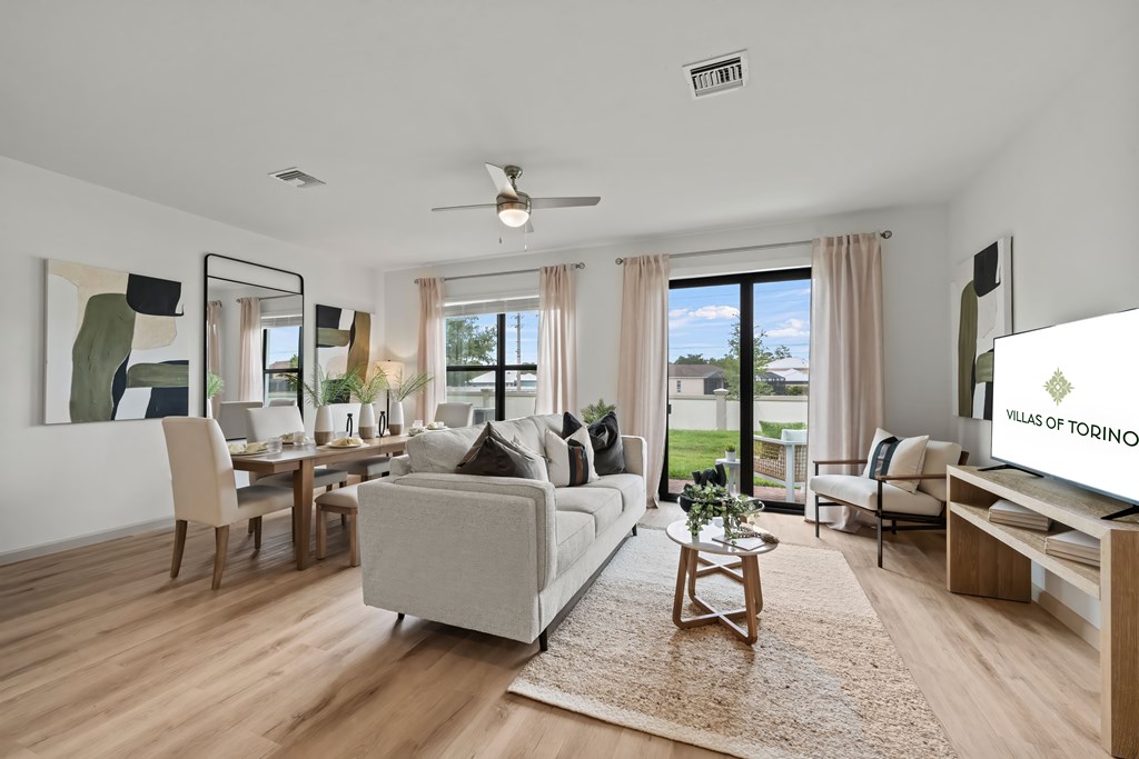 an open living room and dining room with a couch and a table