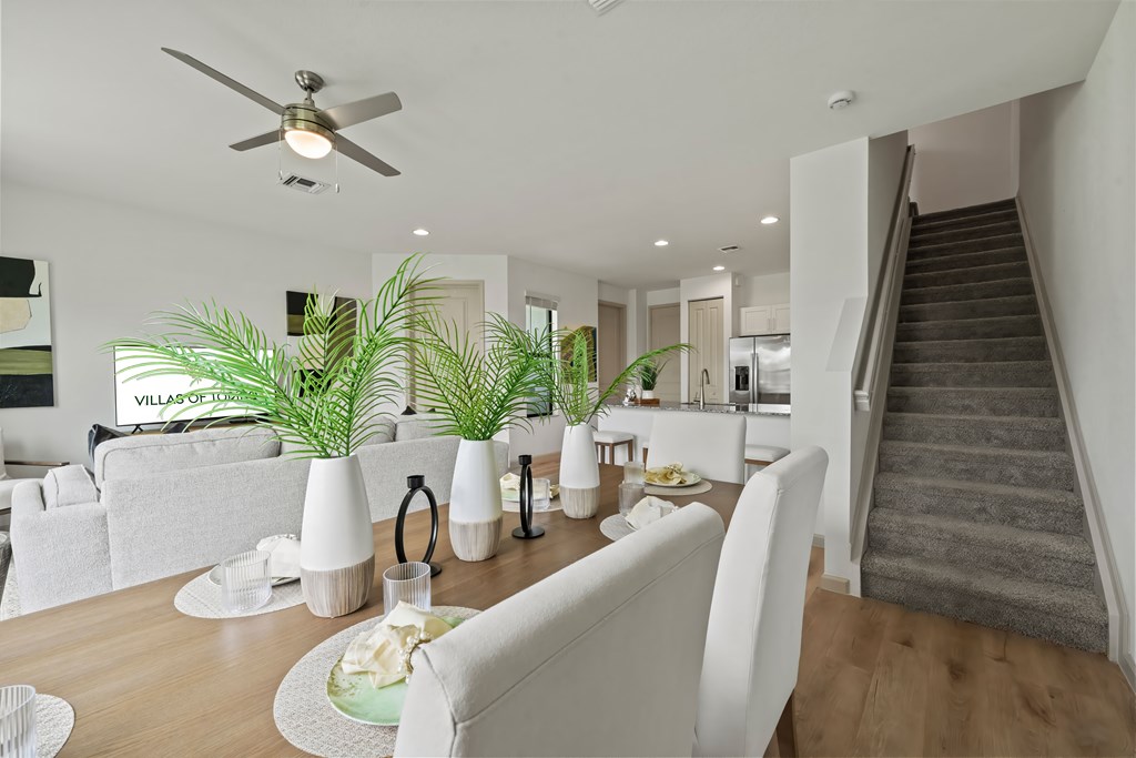 a living room and dining room with a table and chairs