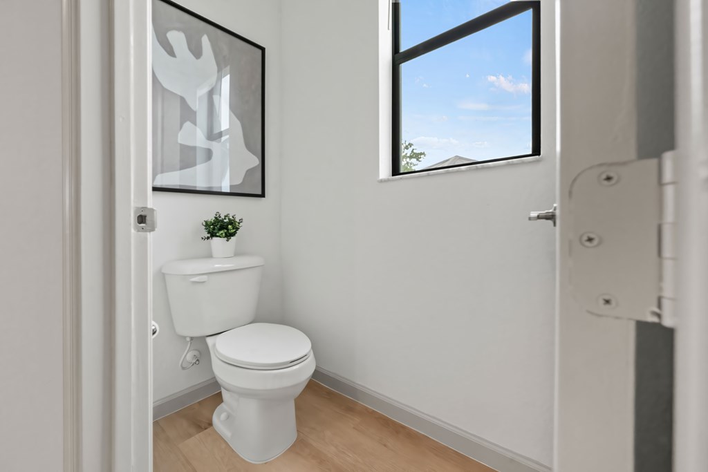 a small bathroom with a toilet and a window