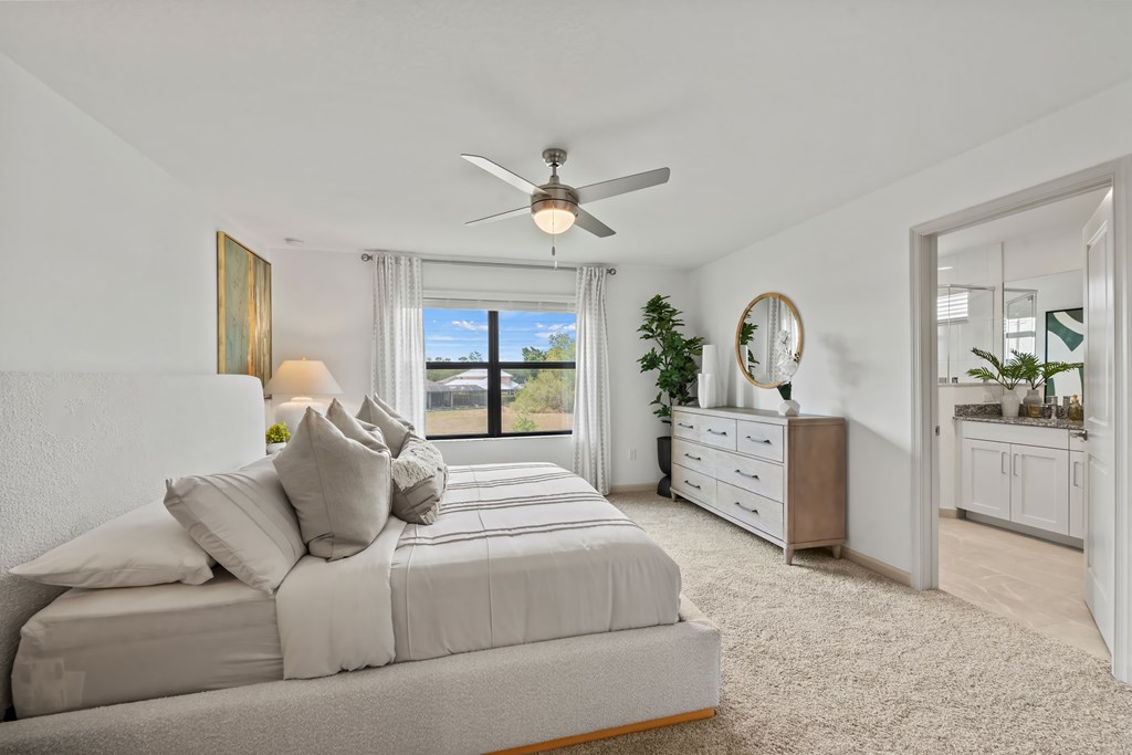 a bedroom with a bed and a ceiling fan