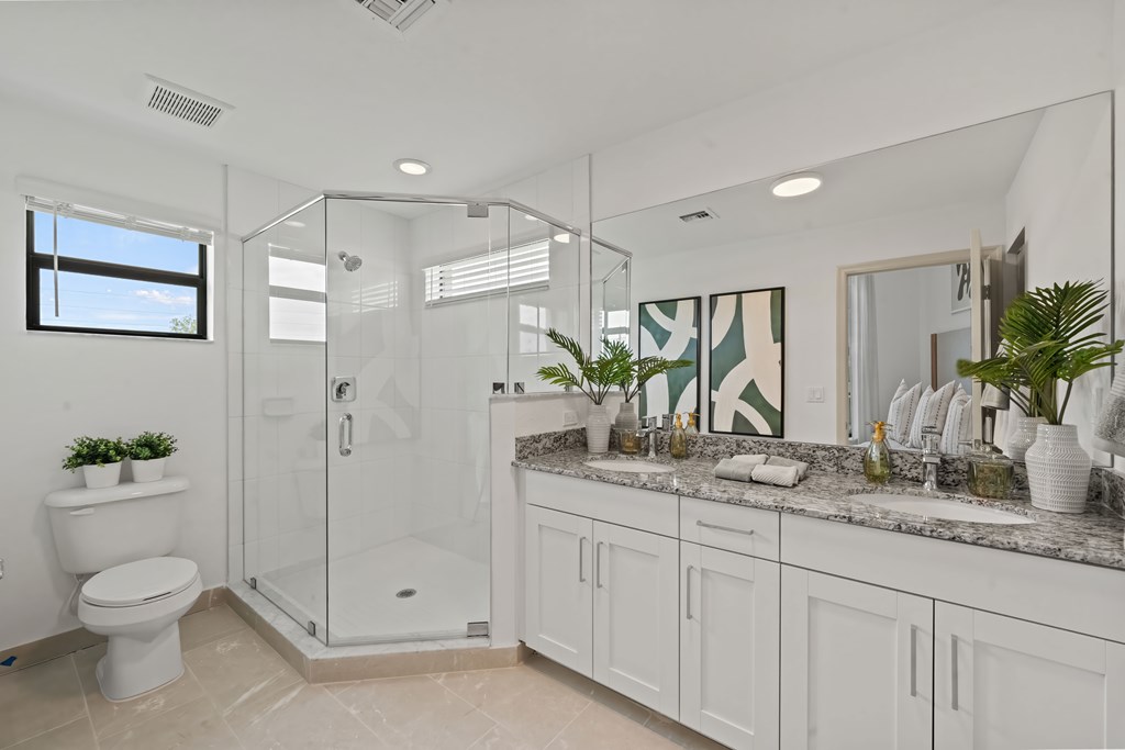 a white bathroom with a shower and a toilet