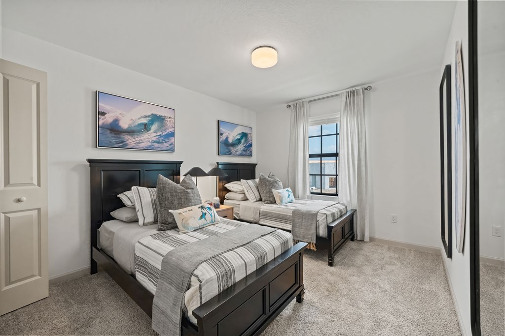 a bedroom with two beds and a window