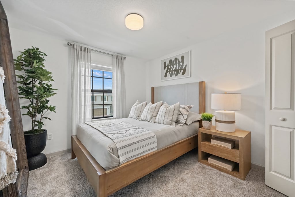 a bedroom with a large bed and a window