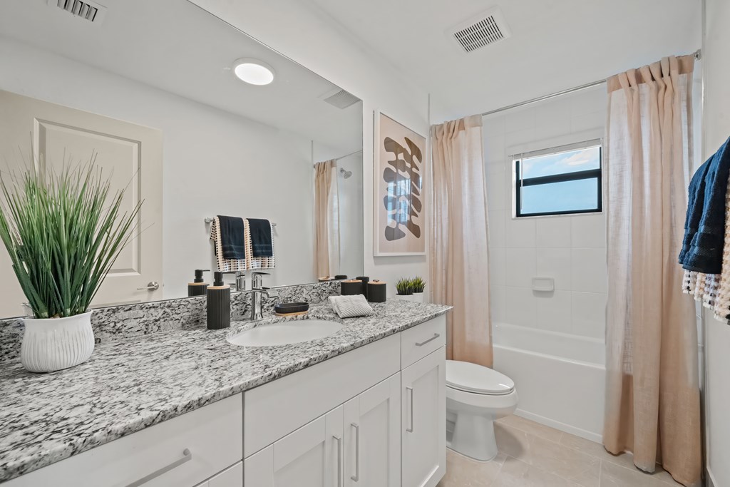 a bathroom with a sink and a toilet and a shower