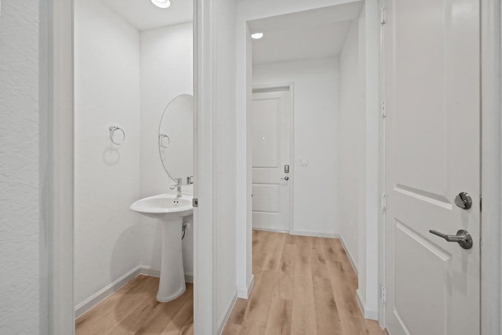 a white bathroom with a sink and a mirror