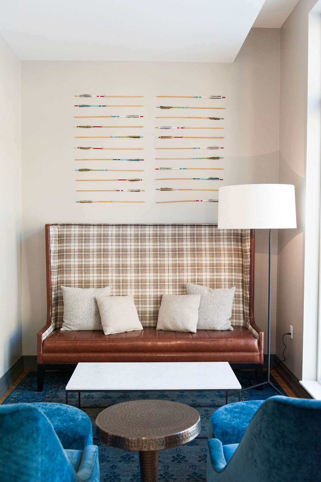 a living room with a couch and a lamp