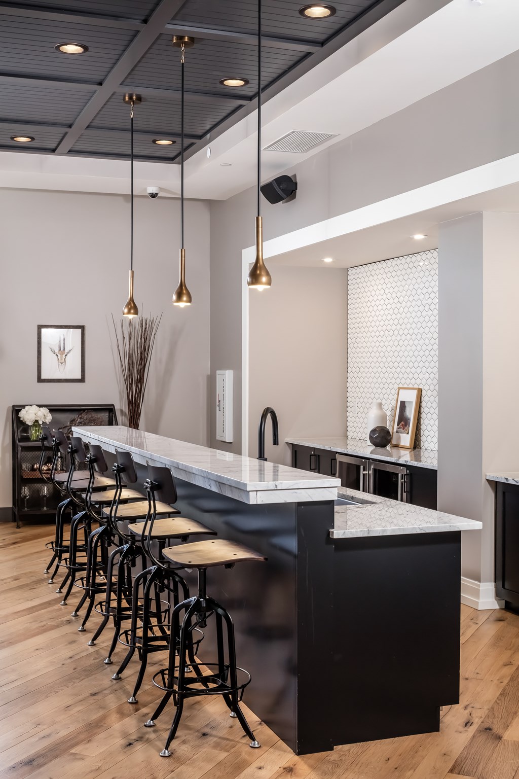 a kitchen with an island and chairs in front of a bar