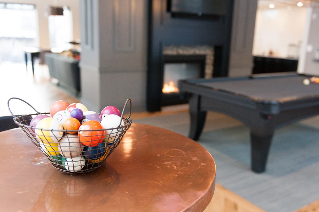 a basket of easter eggs on a table in a living room with a pool