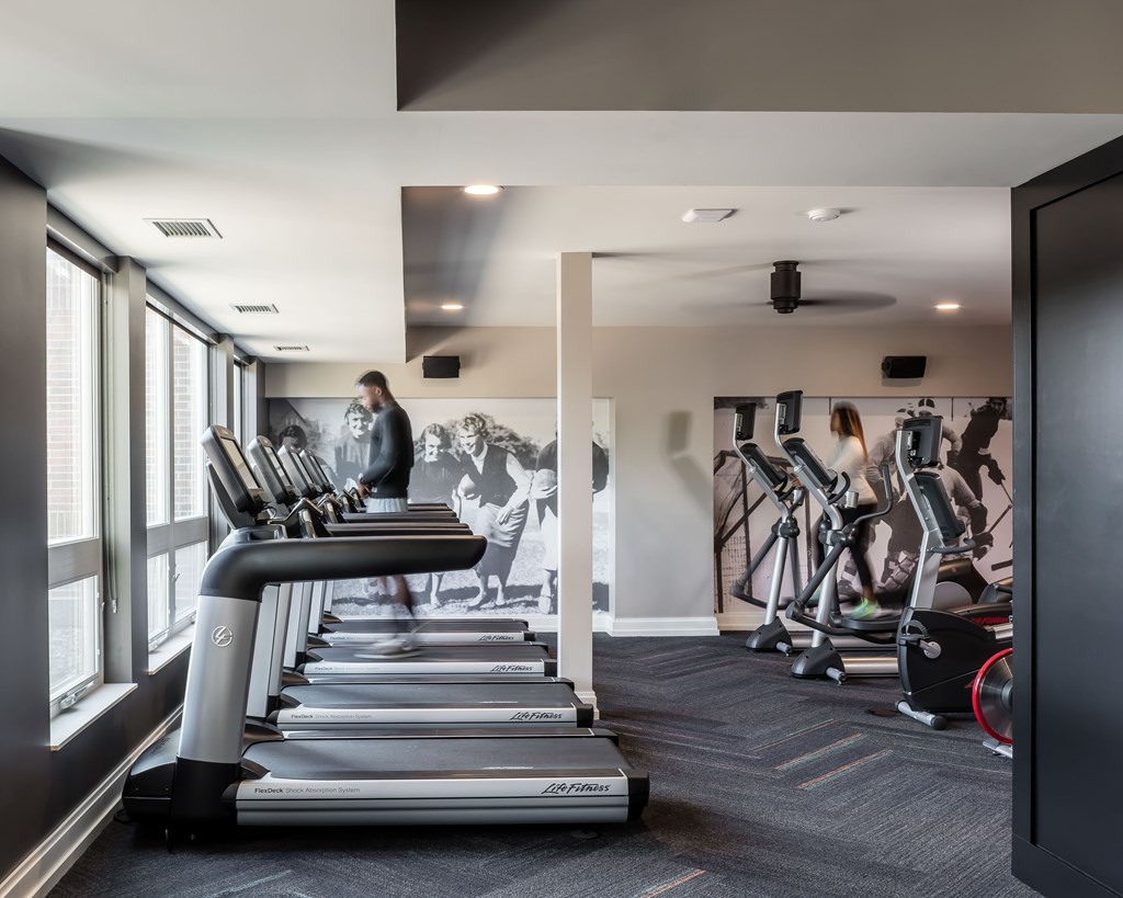 a man walking on a treadmill in a gym