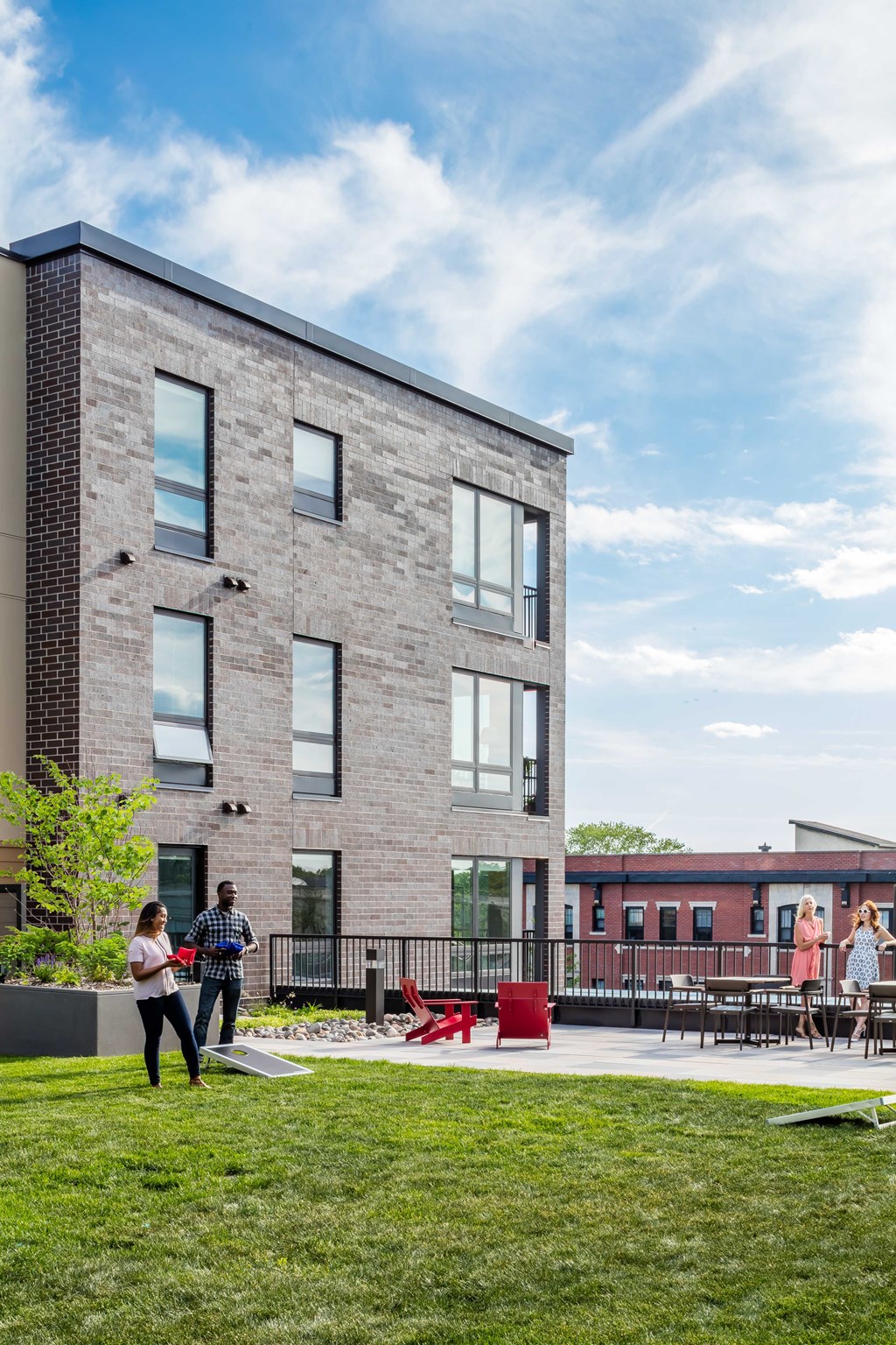 a large brick building with people walking in front of it
