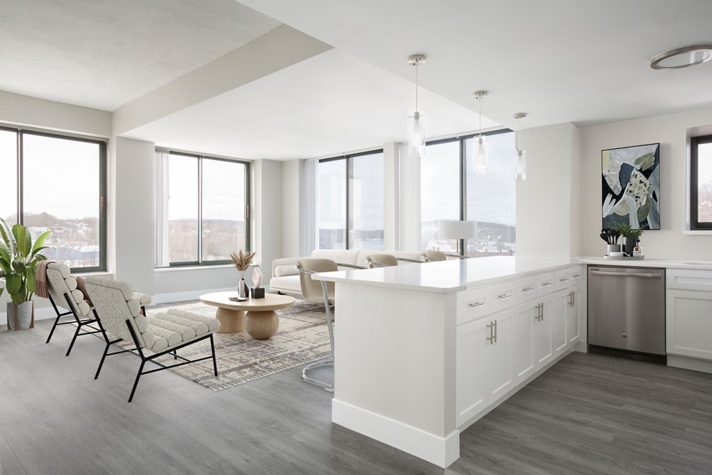 A modern kitchen with white cabinets and a large island.
