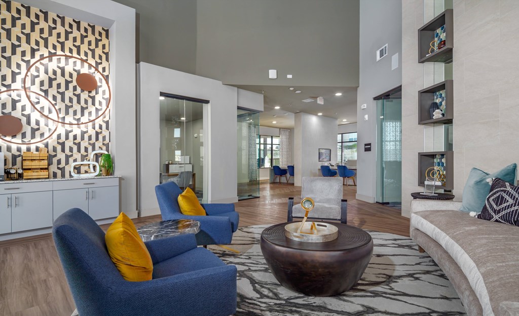 a living room with blue furniture and a large rug