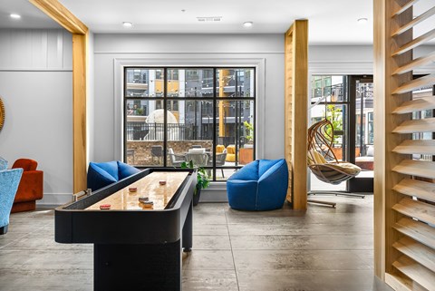 A room with a pool table and a chair.