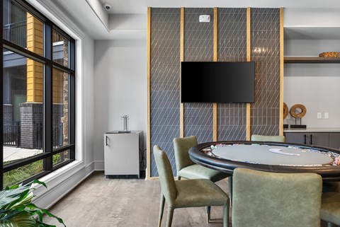 A modern dining room with a round table and chairs.