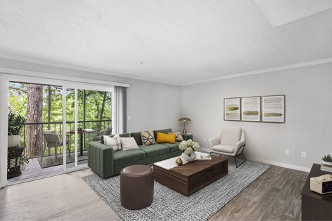 A living room with a green couch and a wooden coffee table.
