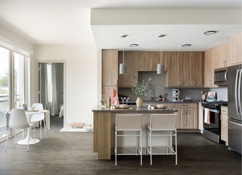 A modern kitchen with a dining table and chairs.