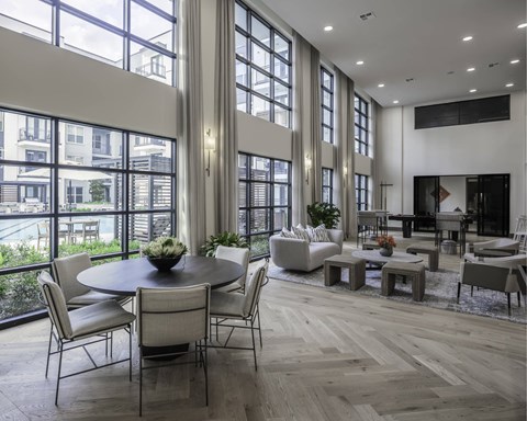 A modern dining room with a round table and chairs.