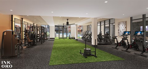 A gym with a green artificial grass area in the middle.