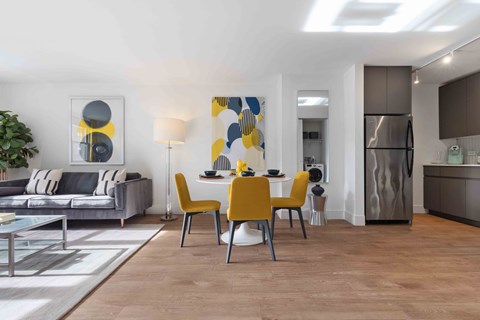 a living room and dining room with a table and chairs