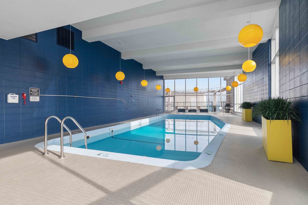 Wave Lakeview Apartments Indoor Heated Swimming Pool with Stylish Decor and Greenery, Overlooking the City