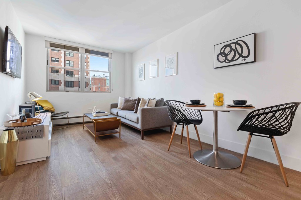 Wave Lakeview Apartments Open Concept Living Room and Dining Area with Wood-Style Flooring and Large Window