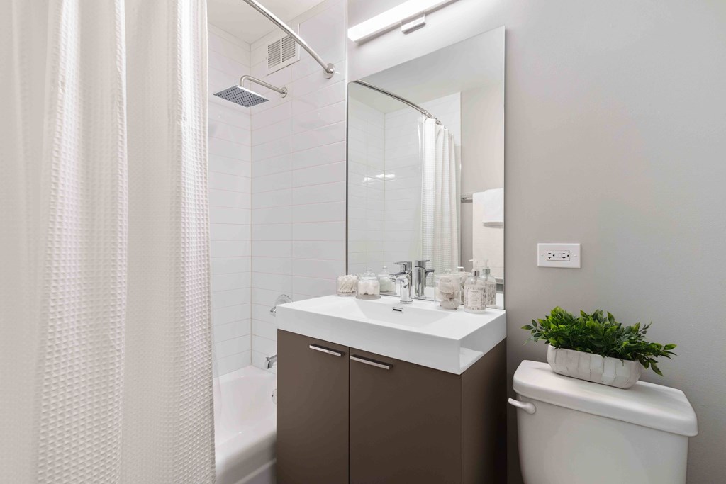 Wave Lakeview Apartments Bathroom with Stylish Fixtures, Shower Tub, and Modern Vanity with Storage