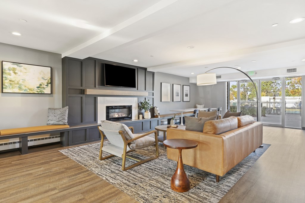 a living room with a leather couch and a fireplace