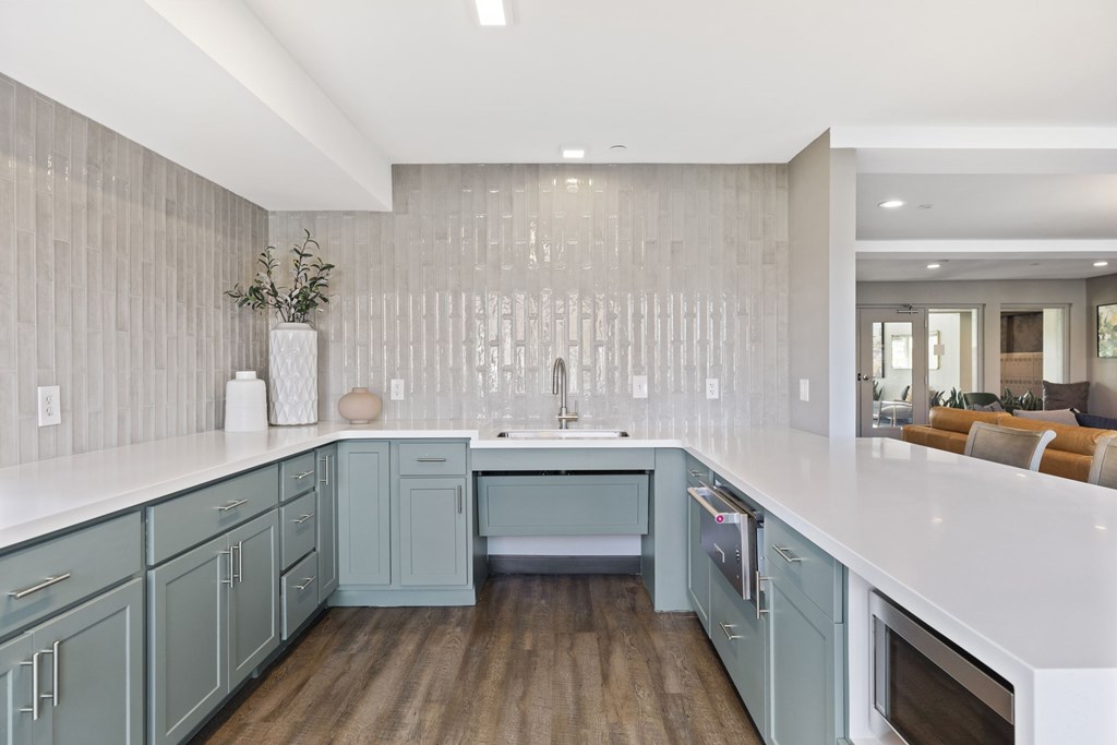 a kitchen with blue cabinets and a white counter top