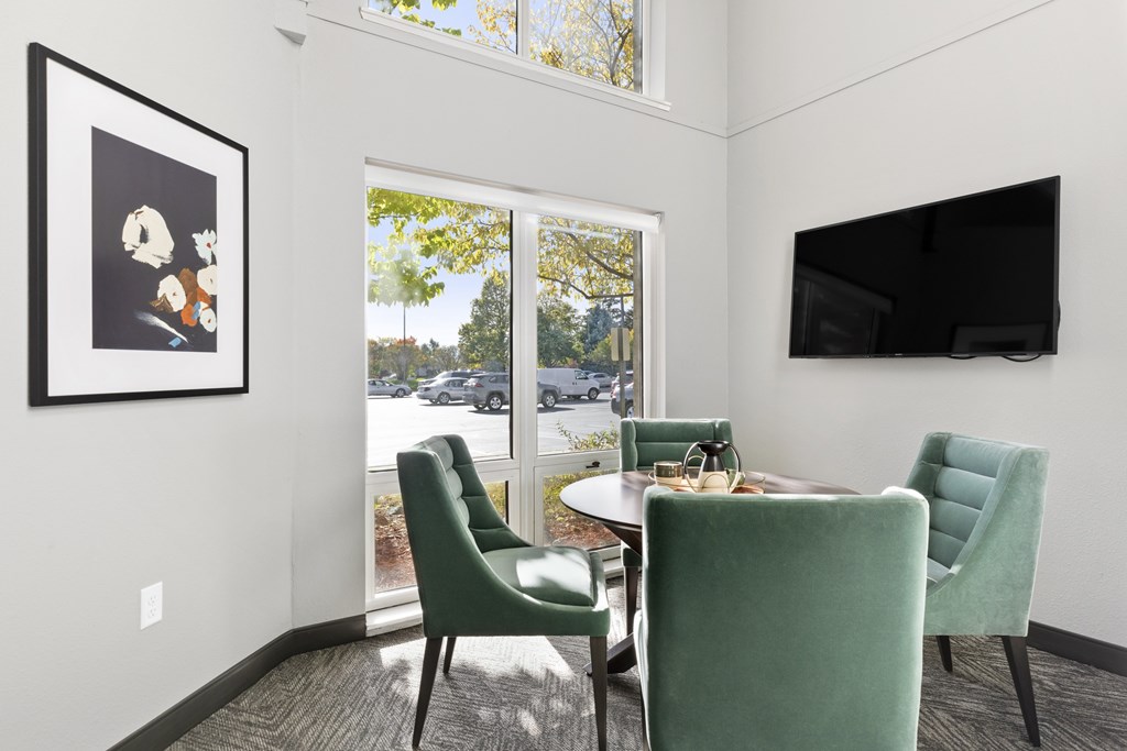 a living room with a table and chairs and a television