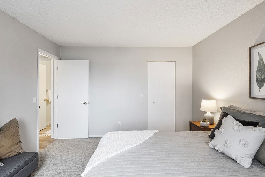 a bedroom with a bed and a couch