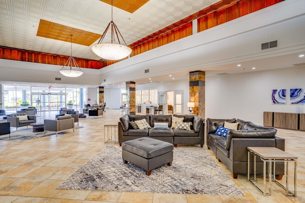 a large lobby with couches and chairs and a table