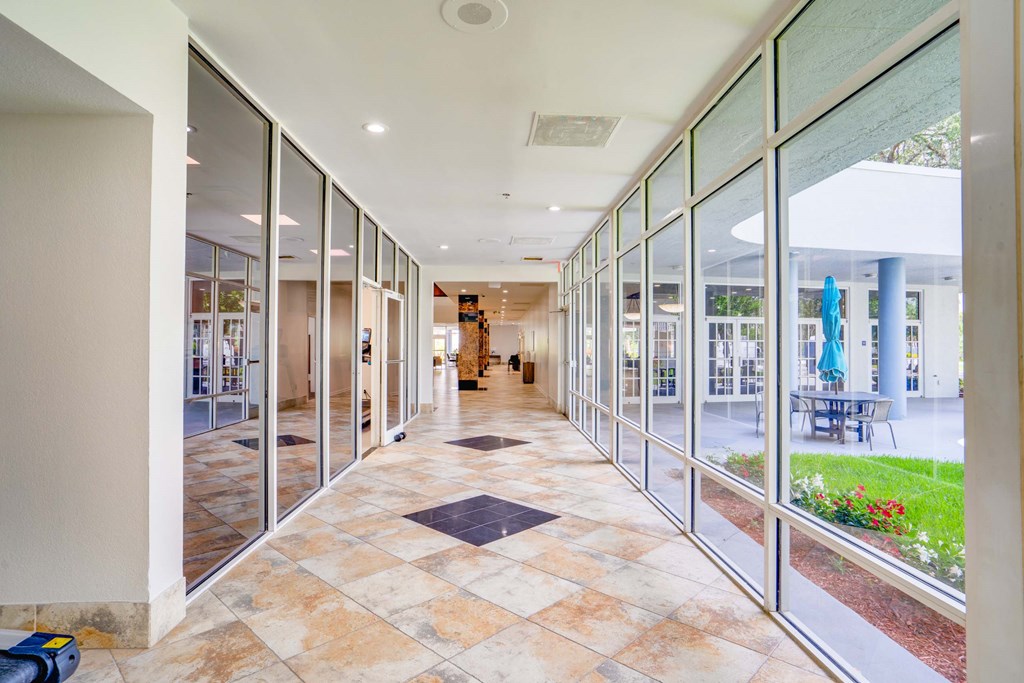 a hallway with glass doors and windows in a building