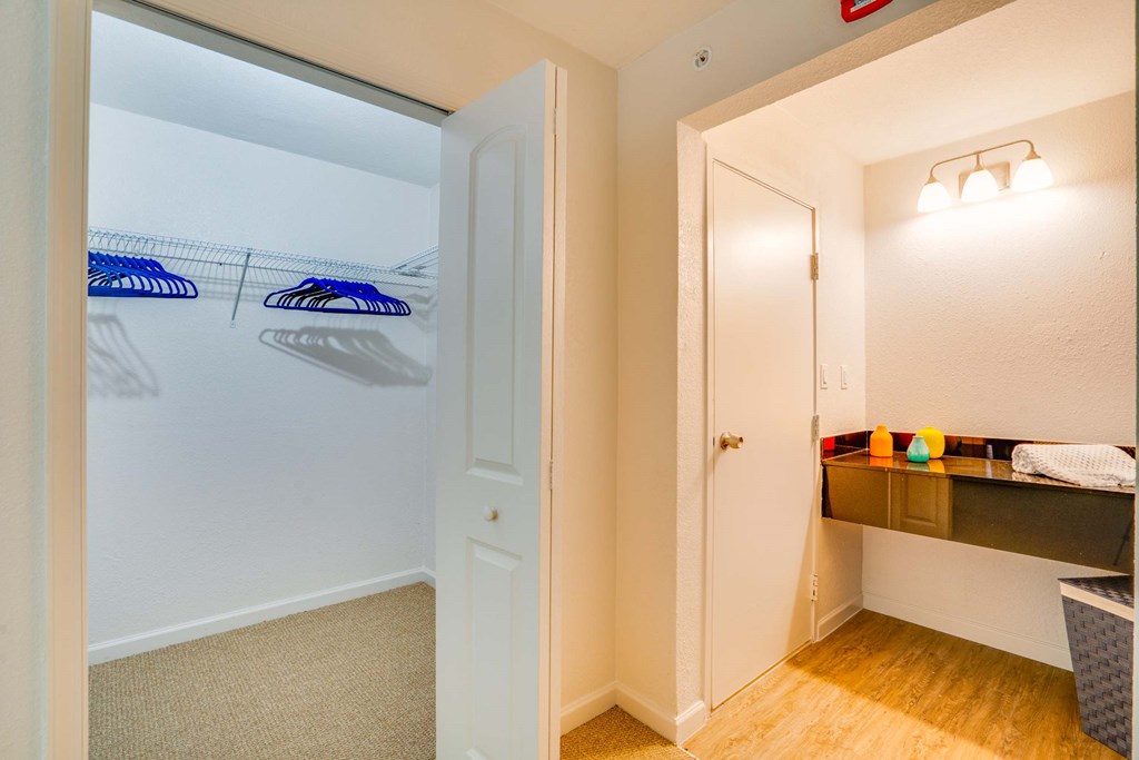 a bedroom with a closet and a door to a bathroom