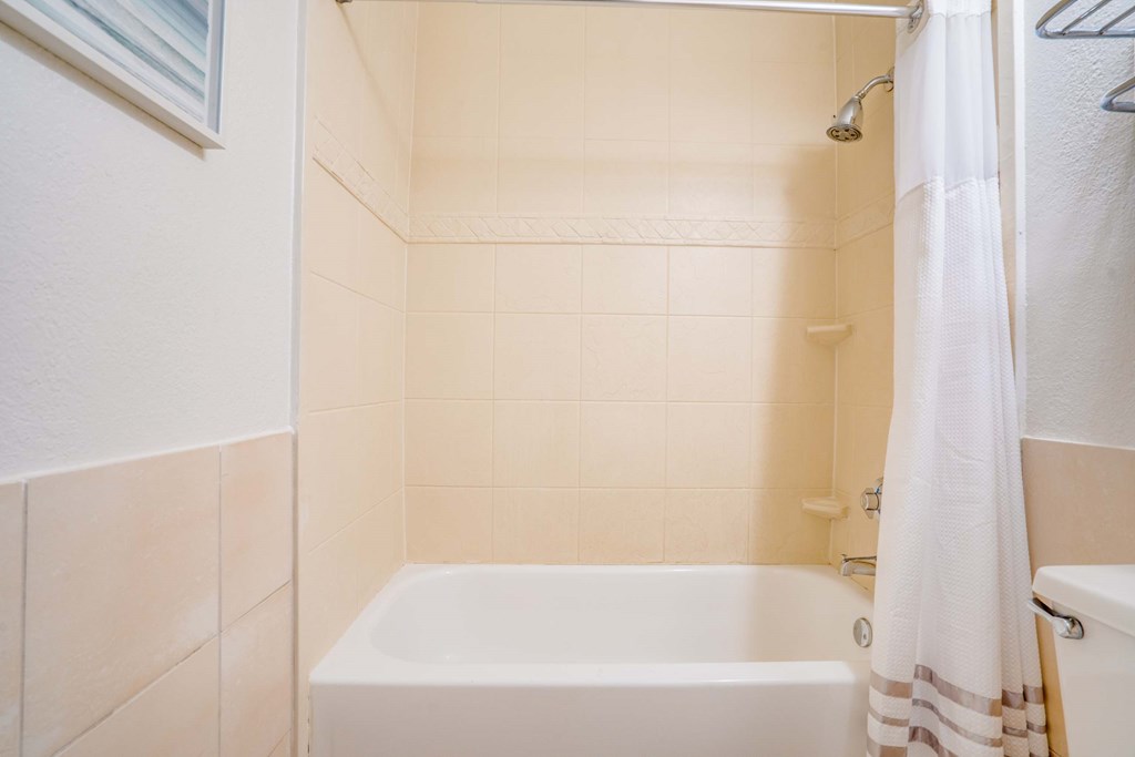 a bathroom with a tub and a shower curtain