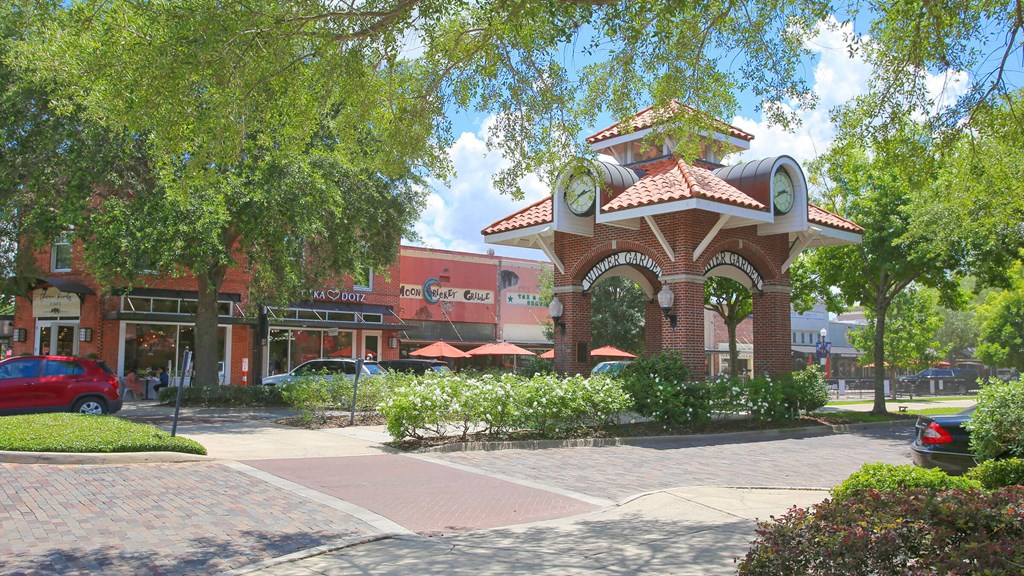 a building with a clock tower in the middle of a street