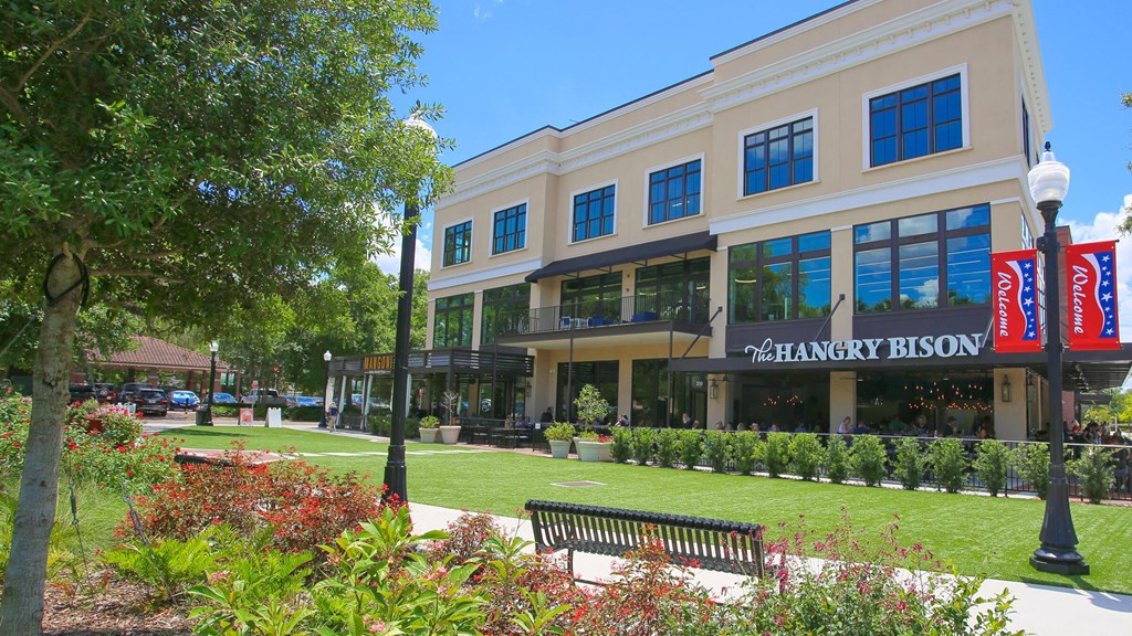a building with a lawn and a bench in front of it
