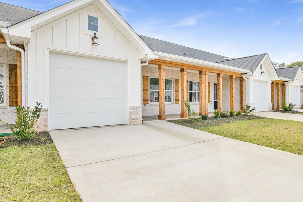a white house with a driveway and a garage door