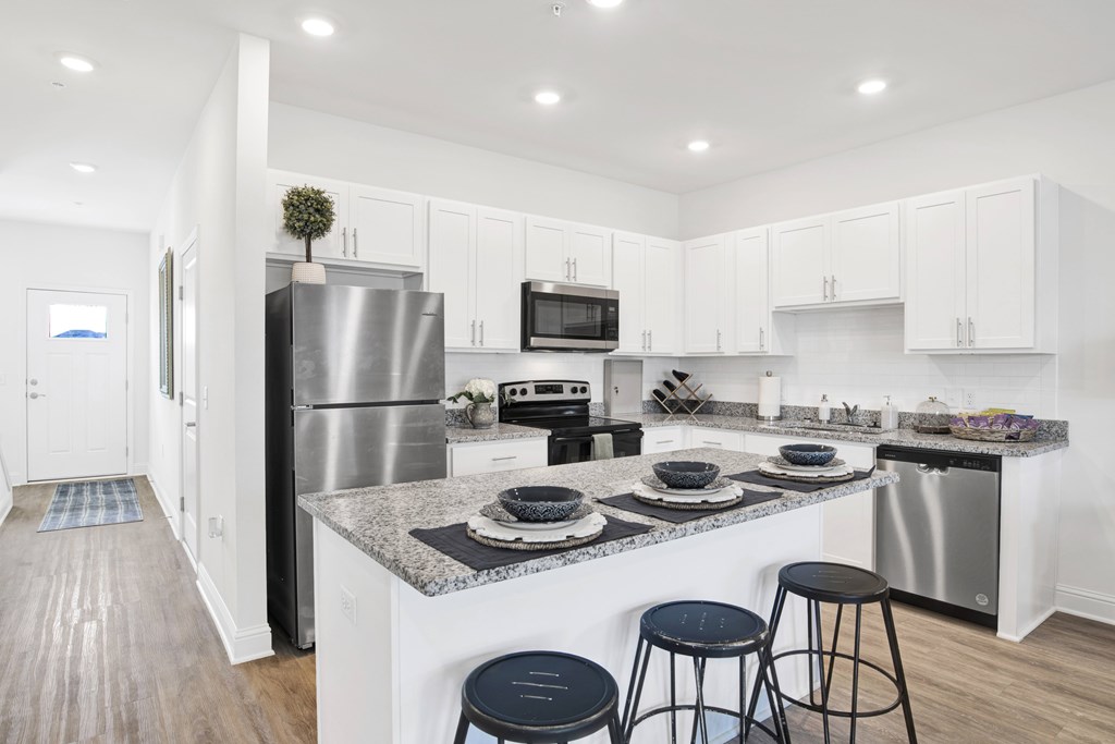 a kitchen with a island and stainless steel appliances