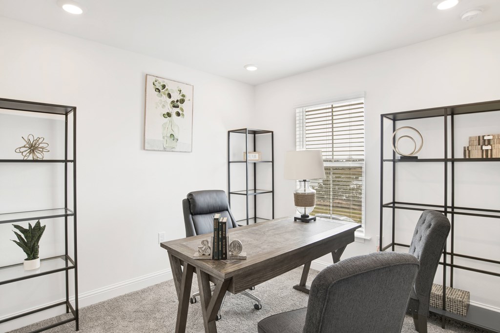 a home office with a desk and chairs
